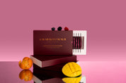 Calmerceuticals premium collagen liquid shots with mango and mandarin on a pink background.